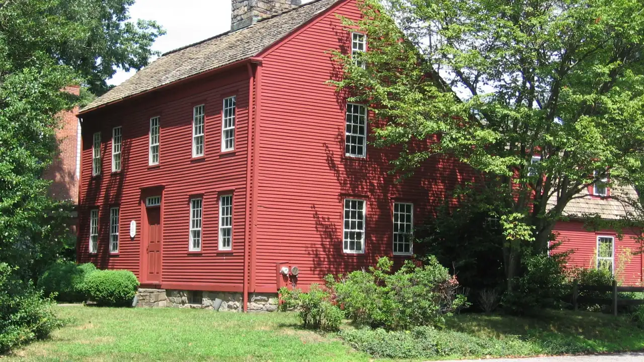 Red clapboard Bates-Scofield House, an eighteenth-century saltbox museum in Darien, Connecticut
